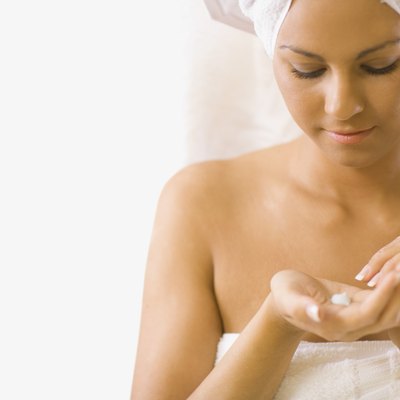 Young woman looking at lotion