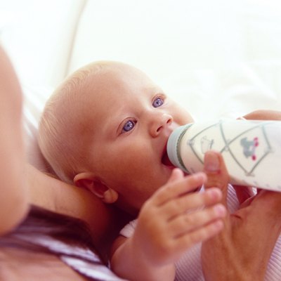 Mother holding feeding baby