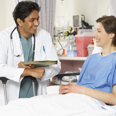 Close-up of a male doctor and a female patient smiling