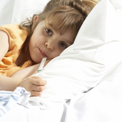 Portrait of a girl with a thermometer in her mouth