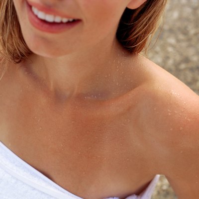 Shoulders of woman wrapped in towel