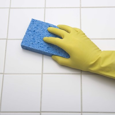 Person using sponge to clean tile