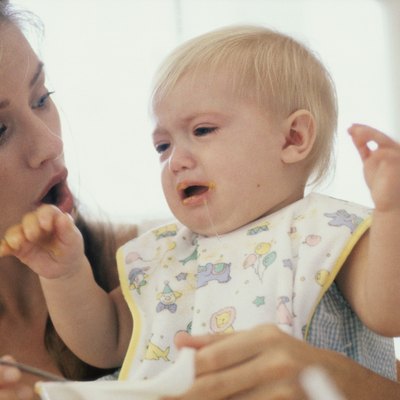 Close-up of a mother feeding her son