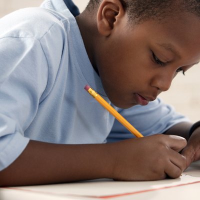Boy writing at school
