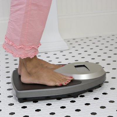 Woman weighing herself
