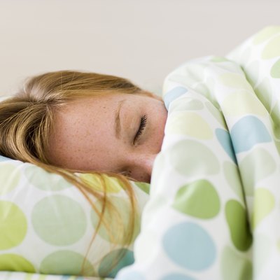 Young woman asleep in bed