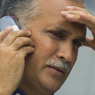 Low angle view of a mature man talking on a mobile phone