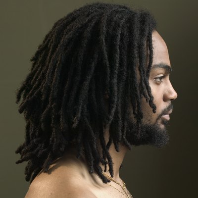 Side profile of a young man with dreadlocks