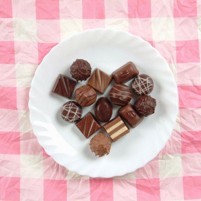 Plate of chocolates on pink tablecloth