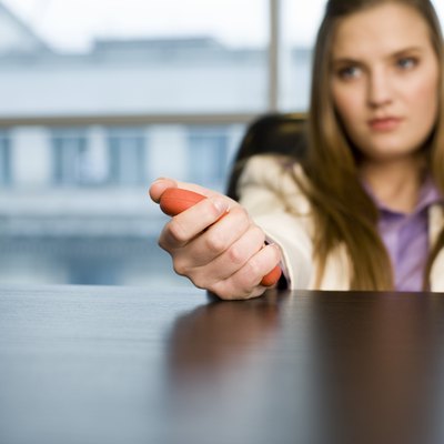 Businesswoman squeezing stress toy