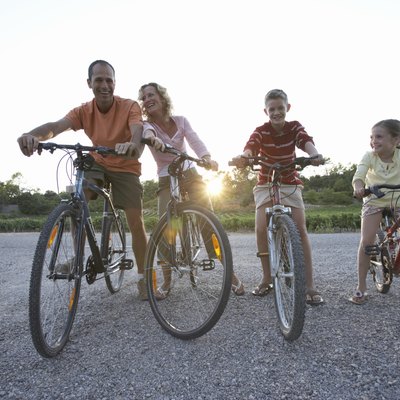 Family with daughter (7-9) and son (11-13) riding bicycles, low angle view