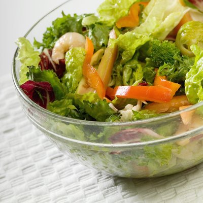 Bowl of salad with shrimp and vegetables, close-up, part of