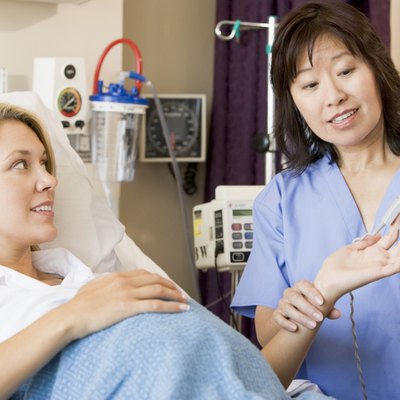 Doctor Taking Pregnant Womans Pulse