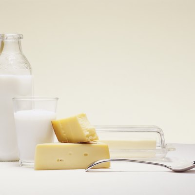 Milk Bottle, Glass of Milk, Cheese, Butter and a Spoon