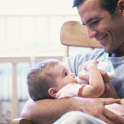 Father feeding his baby boy