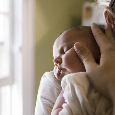 Close-up of a young woman holding her baby