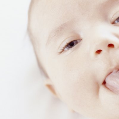 Baby (3-6 months) sticking out tongue, close-up