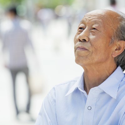 Portrait of smiling senior man, outdoors in Beijing