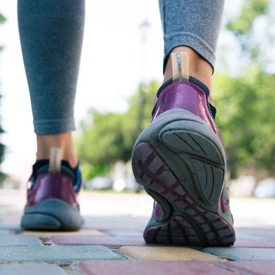 Footwear on female feet running on road