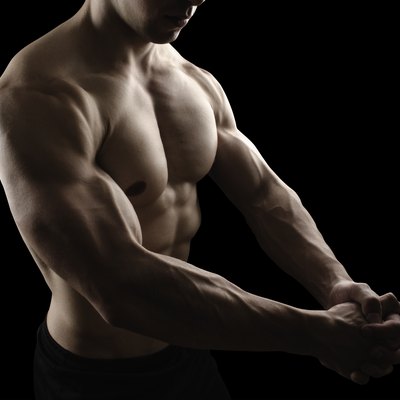 Muscular male body on black background