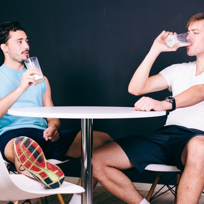Young man drinking protein shake after training in health club