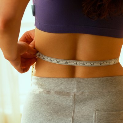Woman measuring her waist