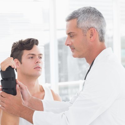 Doctor examining a man wrist