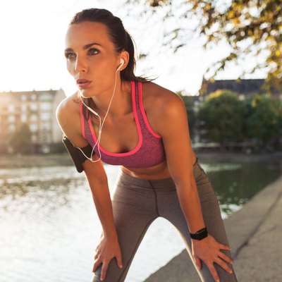Young sportswoman resting after run