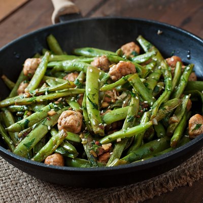 Green beans fried with chicken meatballs and garlic Asian style