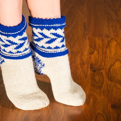 Feet warm beautiful socks on a wooden floor