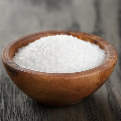 White sugar in olive wood bowl