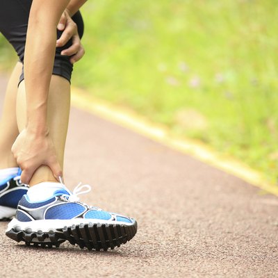woman runner hold twisted ankle