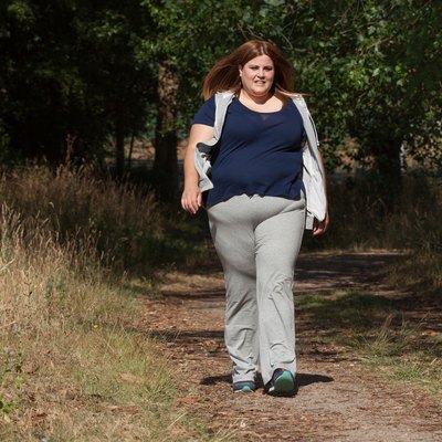 Overweight woman walking outdoors