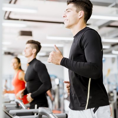 Group of young people using treadmills in a gym
