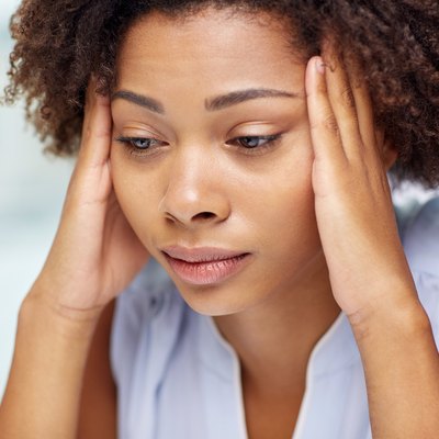 close up of african young woman touching her head