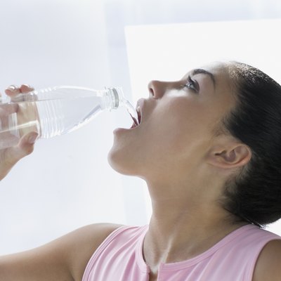 Teen girl drinking from water bottle