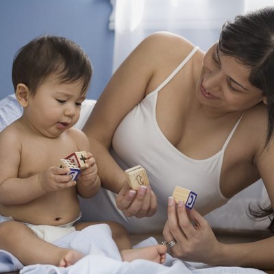 Hispanic mother and baby playing with blocks
