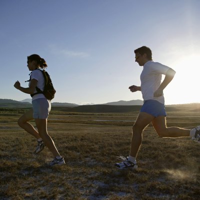 Man and woman running at sunset, California, USA