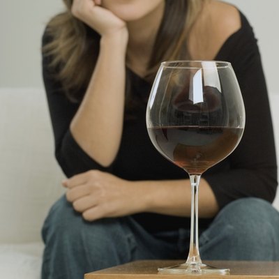 Portrait of a young woman sitting with her hand on her chin
