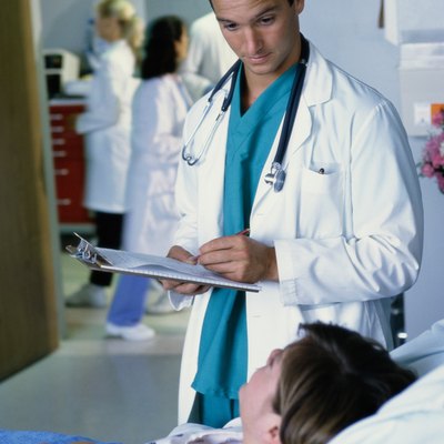 Male doctor taking the report of a patient