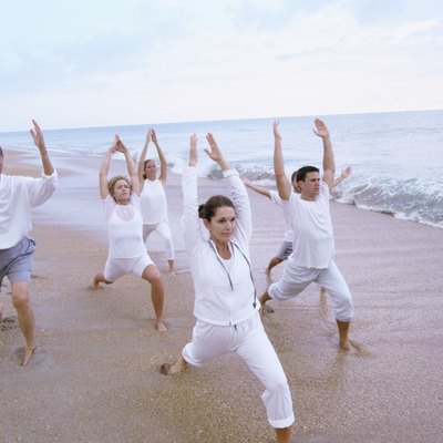 Group of people exercising on the beach