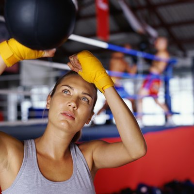 Close-up of a lady boxer hitting a speed bag