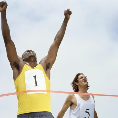 low angle view of male athlete crossing the finish line