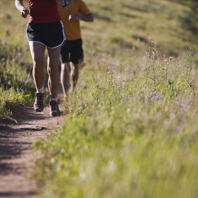 People running along path on hillside
