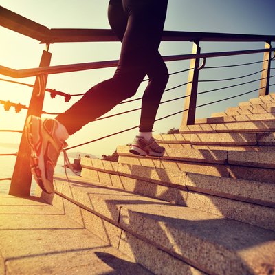 healthy lifestyle asian woman running at stairs seaside