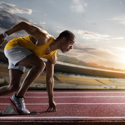 Sport. Sprinter leaving starting blocks on the running track.