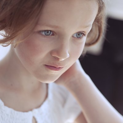 Close-up portrait of young girl looking away from camera