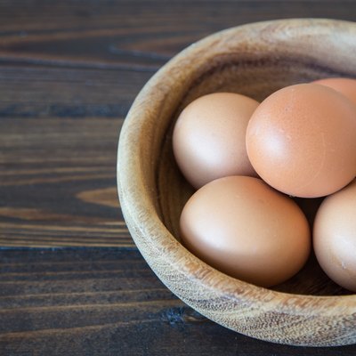 Eggs in wood bowl background