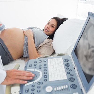 Doctor operating ultrasound machine