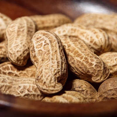 Peanuts in wooden dish closeup macro